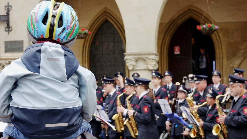 Dieser Junge lauscht der Musik beim Katholikentag in Münster vor dem Historischen Rathaus in der Altstadt